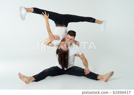 Duo Of Acrobats Showing Tricks, Isolated On White 62898417