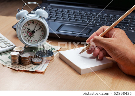 Business male hand use pencil writing on paper 62898425