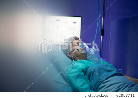 Infected patient in quarantine lying in bed in hospital, coronavirus concept. Infected patient in quarantine lying in bed in hospital, coronavirus concept. 62898711