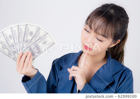 Beautiful young business asian woman holding money isolated on white background Beautiful young business asian woman holding money isolated on white background 62899100