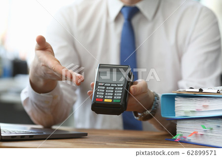 Man holds his hand wireless terminal for payment Man holds his hand wireless terminal for payment 62899571
