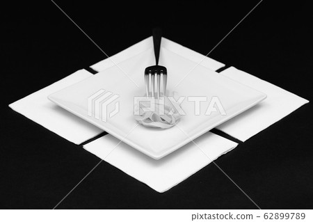 Stainless fork and tagliatelle pasta on the white Stainless fork and tagliatelle pasta on the white 62899789