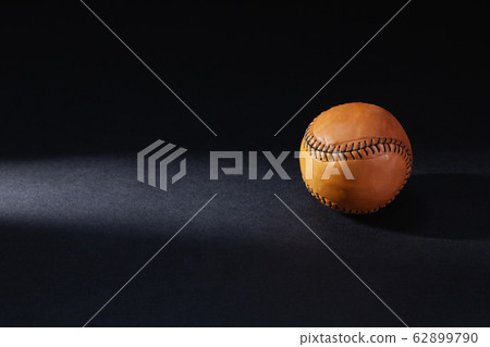 Brown baseball ball ion the black background. Brown baseball ball ion the black background. 62899790