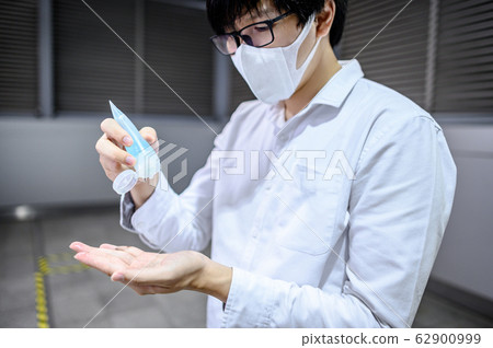 Asian man using hand sanitizer gel washing hand Asian man using hand sanitizer gel washing hand 62900999