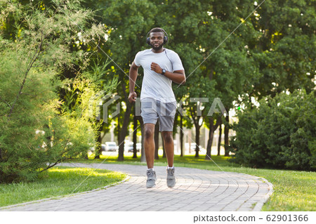 Athletic black guy exercising in public park 62901366