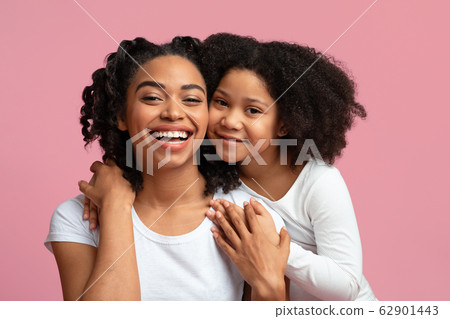 Happy African Mom Posing With Her Adorable Daughter On Pink Background 62901443