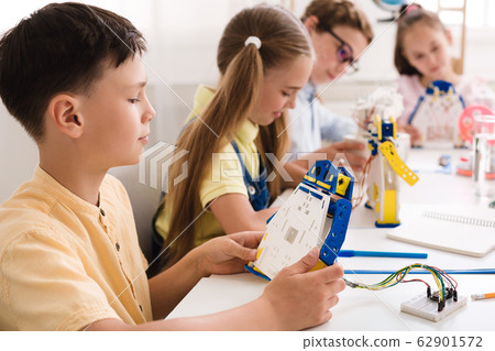 School boy working on project, making diy robot 62901572
