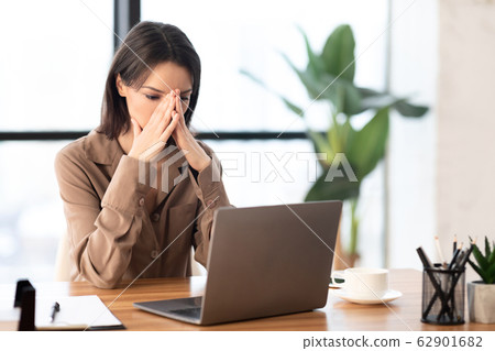 European manager sitting at desktop at workplace European manager sitting at desktop at workplace 62901682