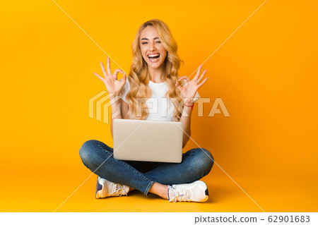 Everything is ok. Happy woman showing okay sign with laptop Everything is ok. Happy woman showing okay sign with laptop 62901683