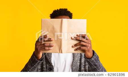 Young african student pretended as if he was reading a book Young african student pretended as if he was reading a book 62901896