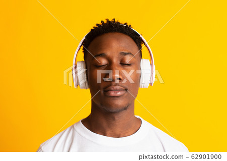 Happy african american man listening to music Happy african american man listening to music 62901900