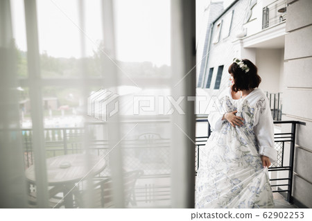 Portrait of beautiful bride with fashion veil at wedding morning 62902253