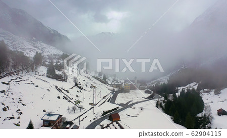 Amazing landscape in the Swiss Alps on a winterÂ´s day - aerial drone footage 62904115