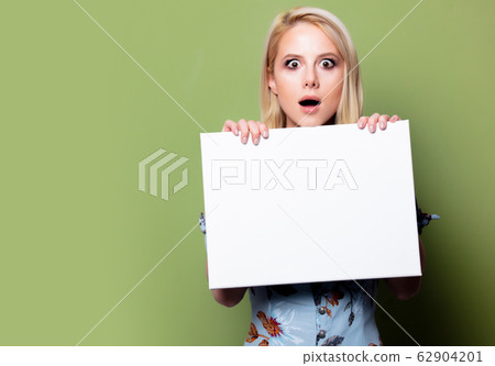 Blonde woman with white banner on green background 62904201