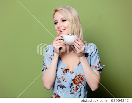 Blonde woman with cup of coffee Blonde woman with cup of coffee 62904242