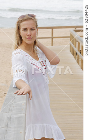 Sexy girl poses for the camera - happy girl on summer vacation at the beach 62904428