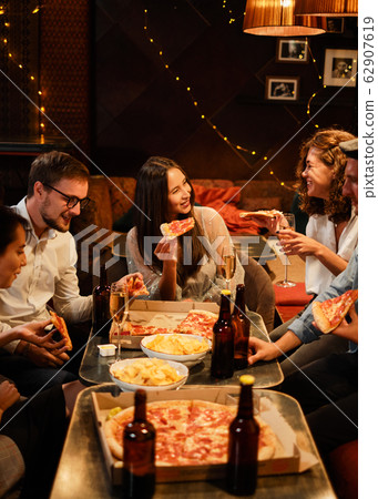 Happy group of friends at the bar having drinks. Happy group of friends at the bar having drinks. 62907619