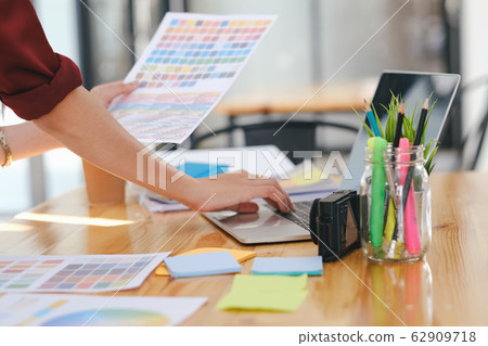 Young photographer and graphic designer at work in Young photographer and graphic designer at work in 62909718