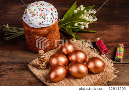 Easter eggs gold and bronze and Easter cake Easter eggs gold and bronze and Easter cake 62911203
