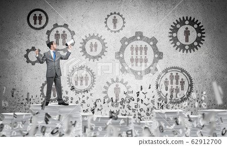 Businessman standing with megaphone. 62912700