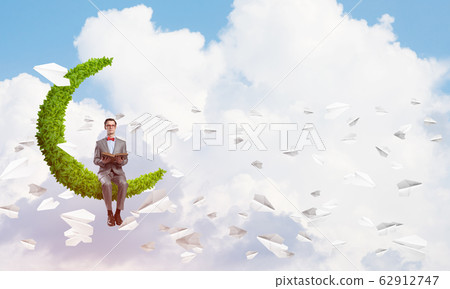 Young businessman or student studying the science and paper planes fly around 62912747