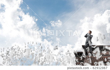 Young man on building edge do not want to see anything Young man on building edge do not want to see anything 62912867