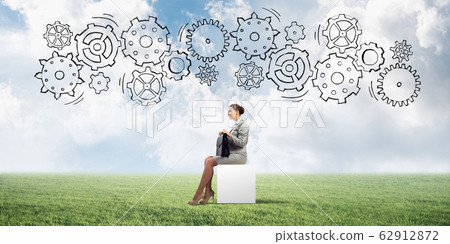 Attractive business lady or accountant outdoors on white box Attractive business lady or accountant outdoors on white box 62912872