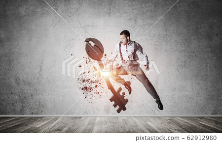 Breaking through access concept with furious man in room crashin Breaking through access concept with furious man in room crashin 62912980