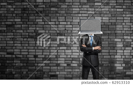 Businessman with laptop instead of head. Businessman with laptop instead of head. 62913310