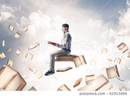Man reading book and many of them flying in air Man reading book and many of them flying in air 62913469