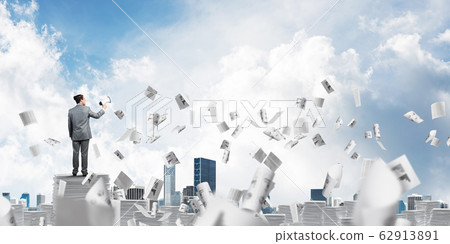 Businessman standing with megaphone. 62913891