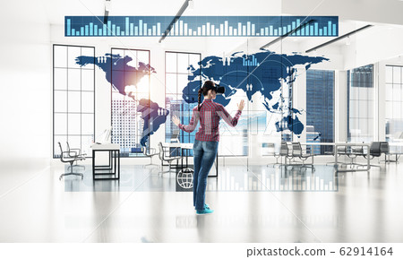 Girl in office interior in virtual reality mask using innovative Girl in office interior in virtual reality mask using innovative 62914164
