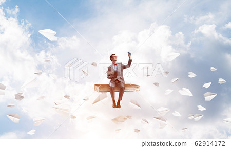 Young businessman or student wearing red glasses studying the science Young businessman or student wearing red glasses studying the science 62914172