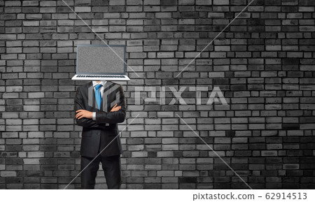 Businessman with laptop instead of head. Businessman with laptop instead of head. 62914513