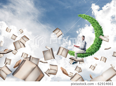 Man reading book and many of them flying in air Man reading book and many of them flying in air 62914661