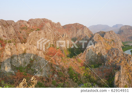 Aerial view of The limestone mountains with brown and green color leaves trees in forest at summer, Public attractions Khao Daeng Viewpoint , Khao Sam Roi Yot National Park, Thailand Aerial view of The limestone mountains with brown and green color leaves trees in forest at summer, Public attractions Khao Daeng Viewpoint , Khao Sam Roi Yot National Park, Thailand 62914931
