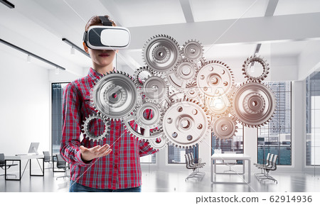 Girl in casual wearing VR glasses and experiencing virtual reality. Mixed media Girl in casual wearing VR glasses and experiencing virtual reality. Mixed media 62914936
