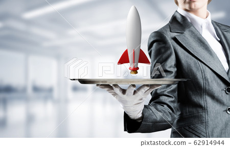Hand of waiter presenting rocket on tray. Hand of waiter presenting rocket on tray. 62914944
