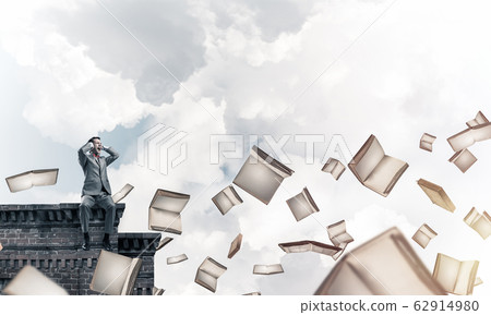 Young man sitting on top and dont want to hear anything Young man sitting on top and dont want to hear anything 62914980
