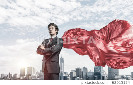 Concept of power and sucess with businessman superhero in big ci 62915134