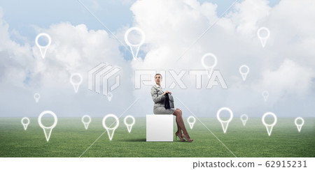 Attractive business lady or accountant outdoors on white box Attractive business lady or accountant outdoors on white box 62915231