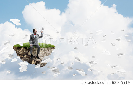 Businessman announcing something in loudspeaker and paper planes fly around Businessman announcing something in loudspeaker and paper planes fly around 62915519