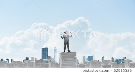 Businessman standing with megaphone. 62915526
