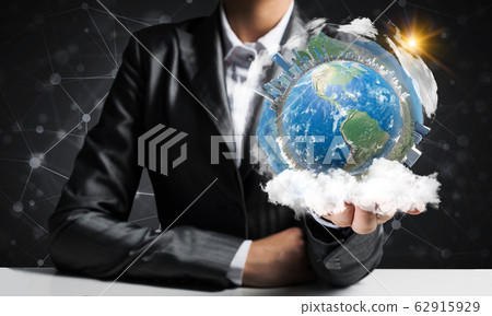 Businessman presenting Earth globe. Businessman presenting Earth globe. 62915929