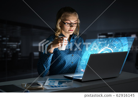 Beautiful blonde in dark office working on laptop and getting net access Beautiful blonde in dark office working on laptop and getting net access 62916145