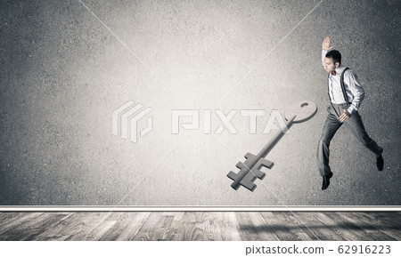 Breaking through access concept with man in room crashing concre Breaking through access concept with man in room crashing concre 62916223