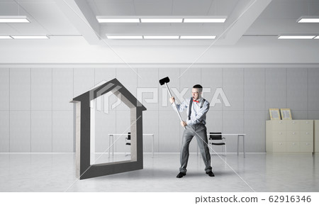 Stone home silhouette as symbol for real estate insurance crashed with man Stone home silhouette as symbol for real estate insurance crashed with man 62916346