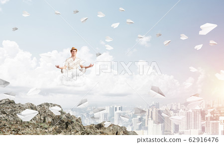 Young man keeping mind conscious. Young man keeping mind conscious. 62916476