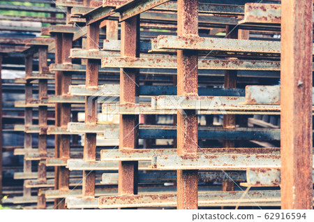 Abstract pattern of corroded metal angled bars 62916594