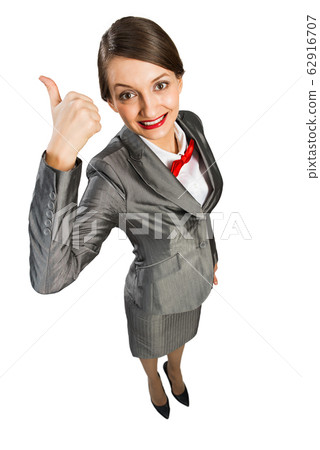 Happy emotion business lady showing thumb up and looking in camera Happy emotion business lady showing thumb up and looking in camera 62916707